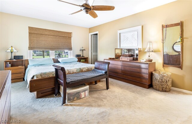 bedroom featuring ceiling fan, a closet, and light carpet