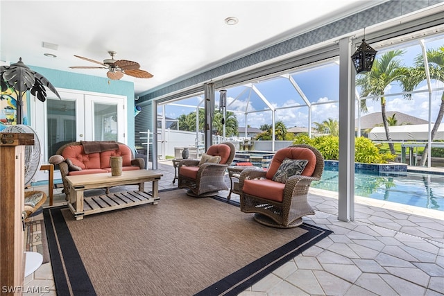 sunroom / solarium with ceiling fan, french doors, and a pool