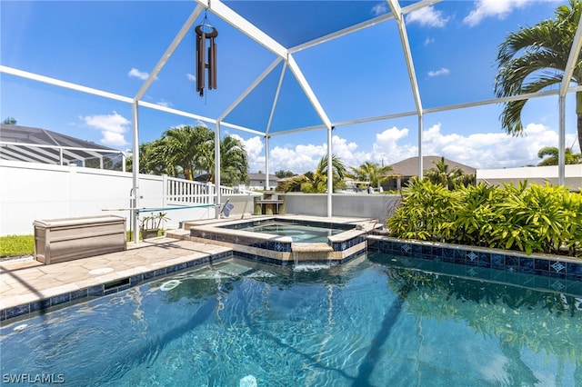 view of pool with a lanai, an in ground hot tub, and a patio