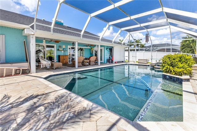 view of pool featuring ceiling fan, a lanai, a jacuzzi, and a patio area