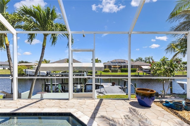 exterior space with a lanai, a water view, and a boat dock