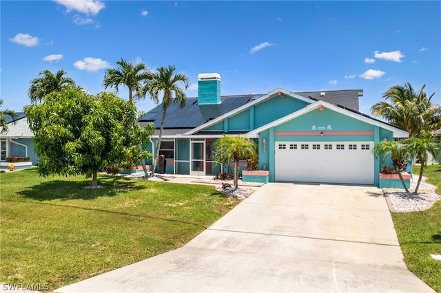 view of front of house featuring a garage, a front lawn, and solar panels