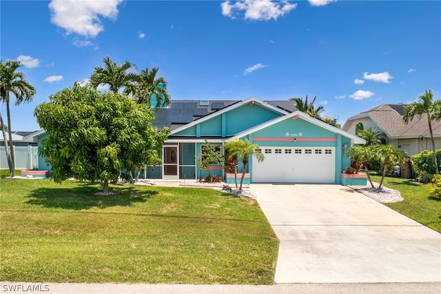 view of front of house with a garage, a front yard, and solar panels