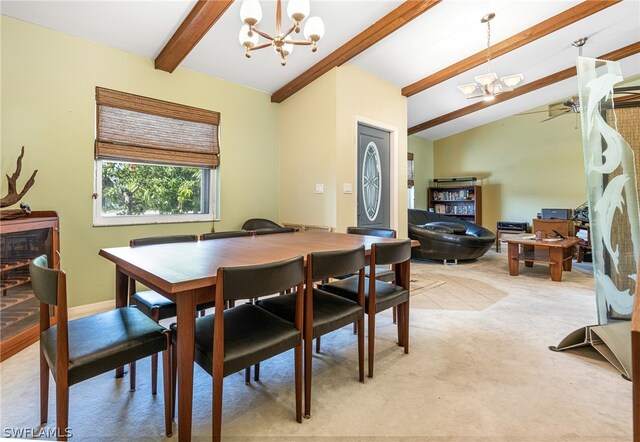 carpeted dining space featuring lofted ceiling with beams and ceiling fan with notable chandelier