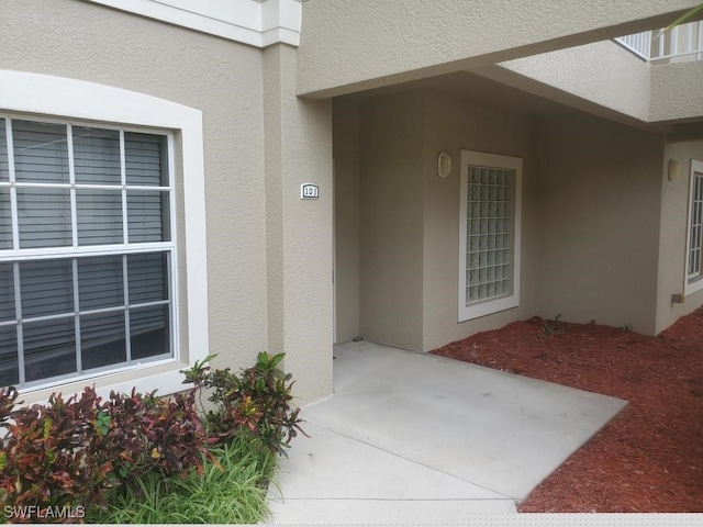 entrance to property featuring a patio