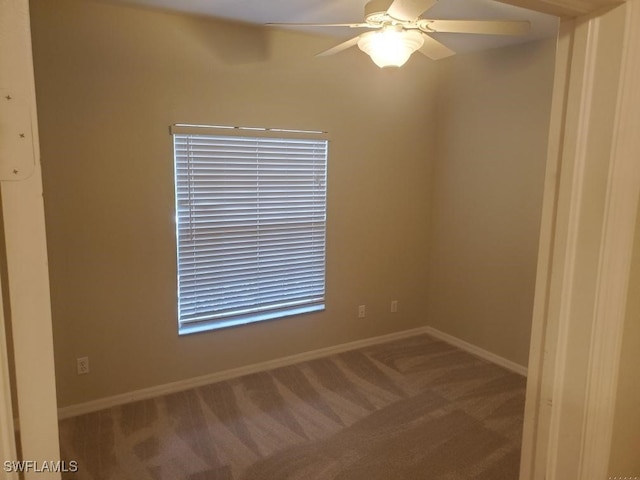 carpeted spare room with ceiling fan