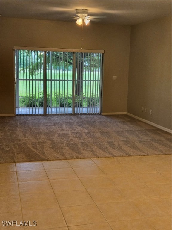 carpeted spare room with ceiling fan