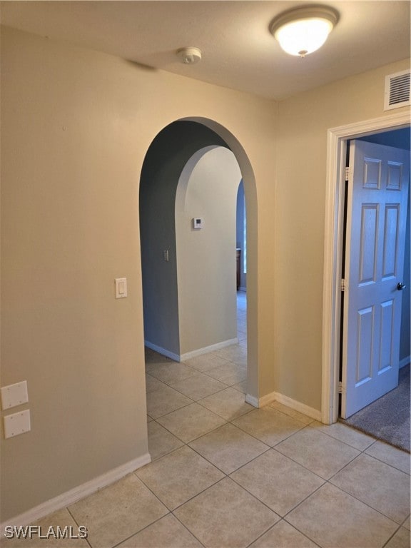 hall featuring light tile patterned flooring