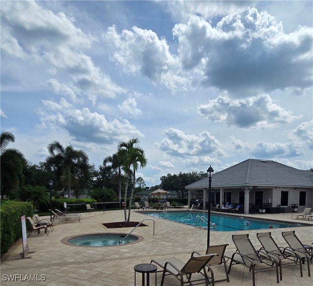 view of pool featuring a patio and a hot tub