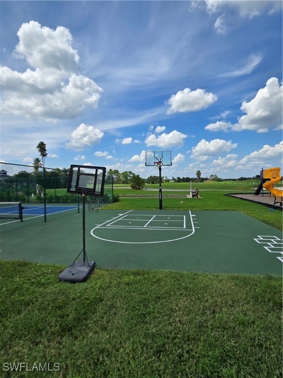 view of basketball court featuring a lawn