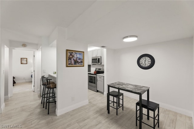 dining space with light wood-type flooring