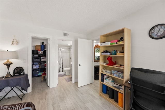 living area featuring a textured ceiling and light wood-type flooring