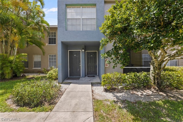 201 Santa Clara Dr Unit 13, Naples, FL 34104 - doorway to property with stucco siding