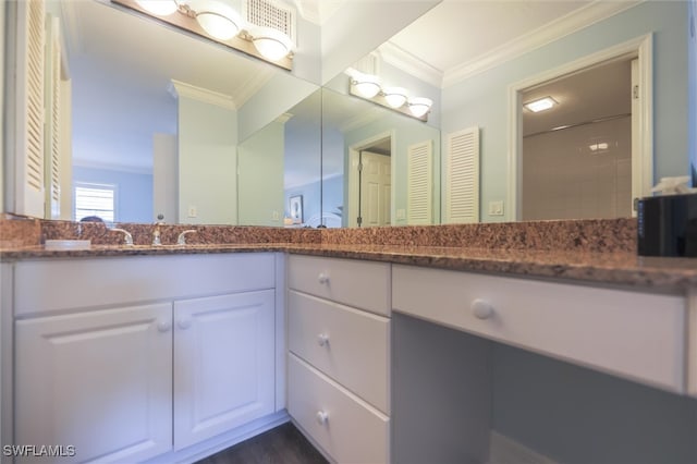 bathroom featuring crown molding and vanity