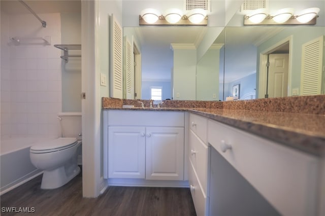 full bathroom featuring tiled shower / bath, hardwood / wood-style flooring, vanity, and toilet