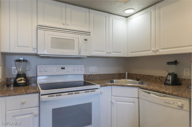 kitchen featuring white cabinets and white appliances