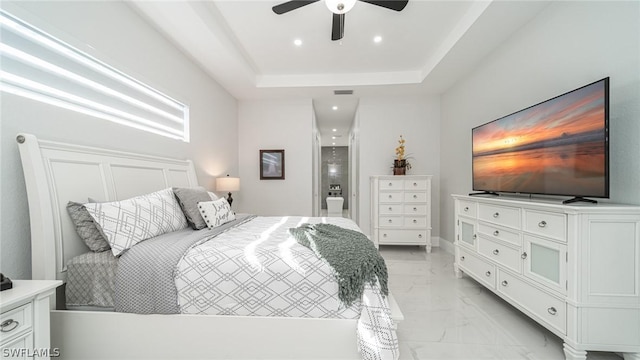 bedroom with a tray ceiling and ceiling fan