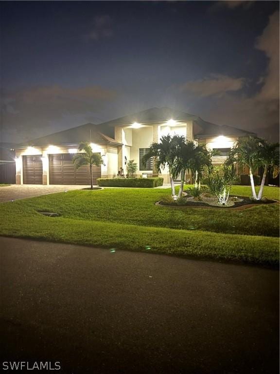 view of front facade with a garage and a front yard