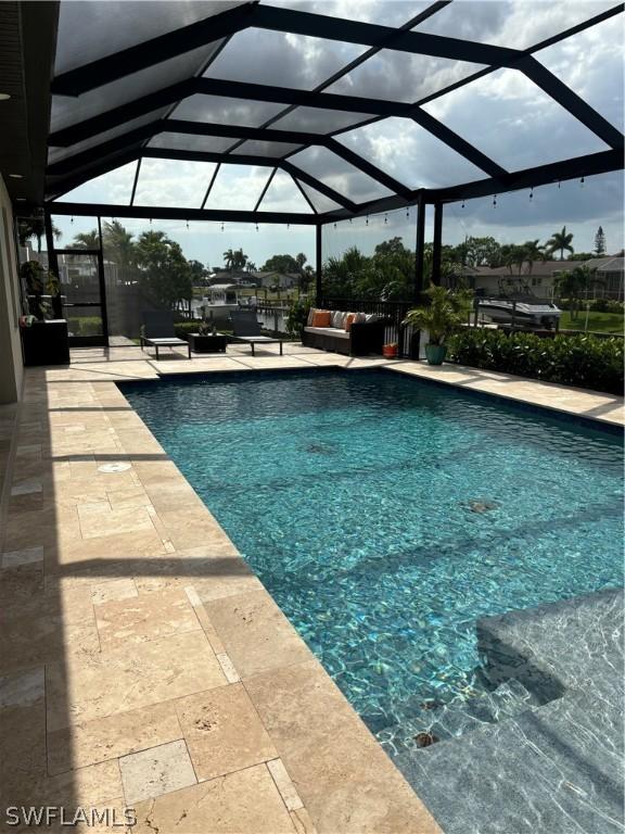 view of pool featuring outdoor lounge area, a lanai, and a patio