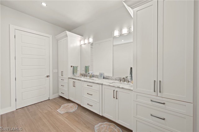 bathroom with vanity and hardwood / wood-style flooring