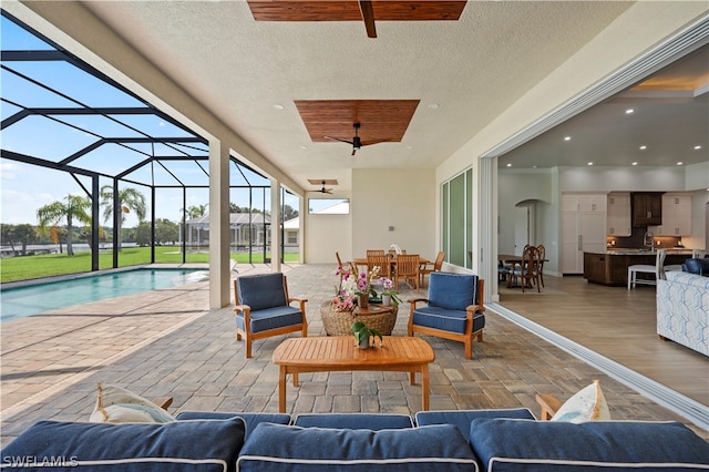 view of patio / terrace with glass enclosure, an outdoor living space, and ceiling fan