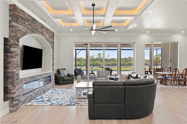 living room with a fireplace, ornamental molding, ceiling fan, beam ceiling, and coffered ceiling