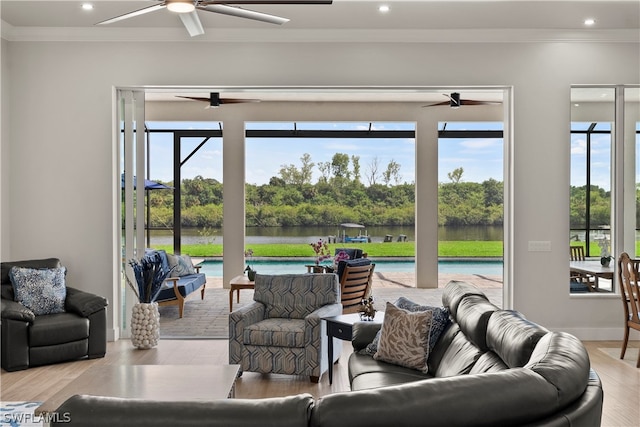 living room featuring ornamental molding, a water view, and light hardwood / wood-style flooring