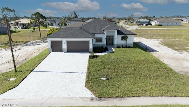 view of front facade with a garage and a front yard