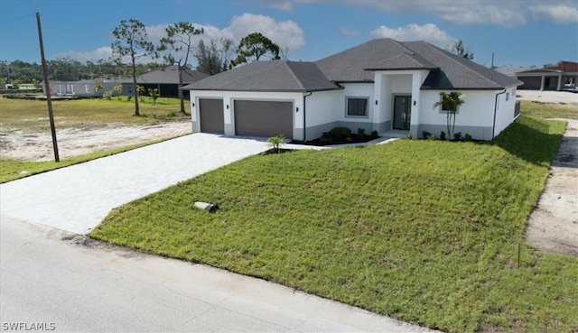 view of front of home featuring a garage and a front lawn