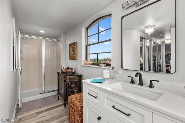 bathroom with vanity, wood-type flooring, and walk in shower