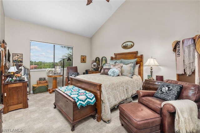 bedroom featuring ceiling fan, light carpet, and vaulted ceiling