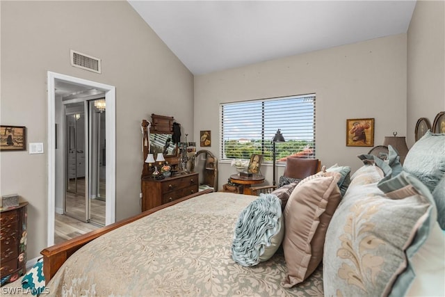 bedroom featuring light hardwood / wood-style floors and lofted ceiling