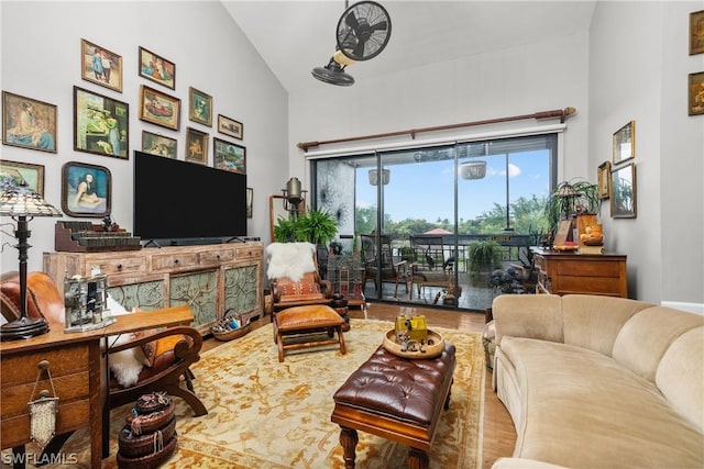 living room featuring wood-type flooring and vaulted ceiling