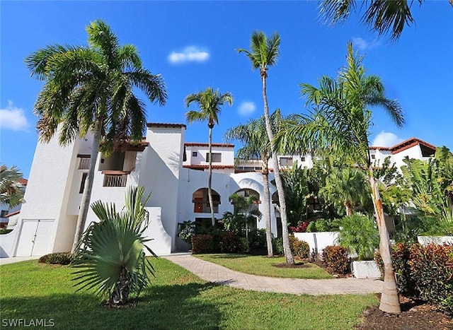 mediterranean / spanish home featuring a front yard