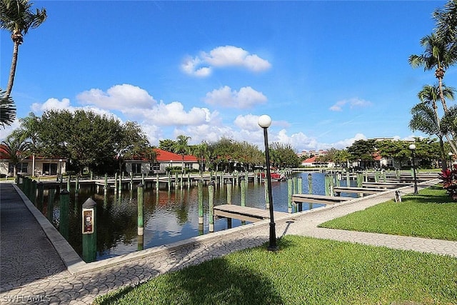 dock area featuring a lawn and a water view