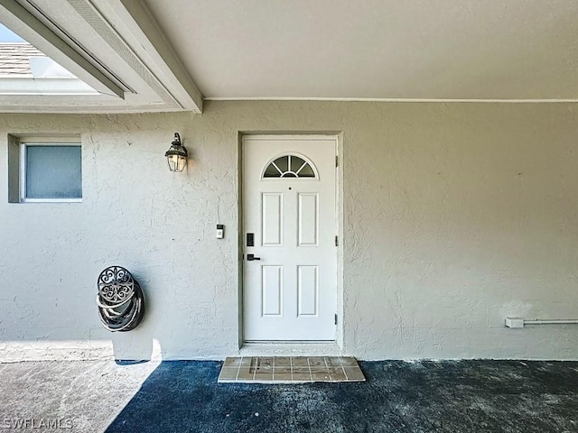 entrance to property with stucco siding