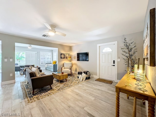 living room with light hardwood / wood-style floors and ceiling fan