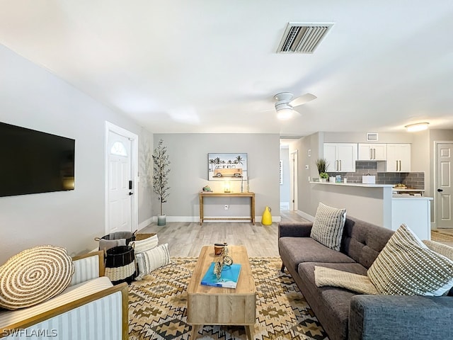 living room with ceiling fan and light hardwood / wood-style floors