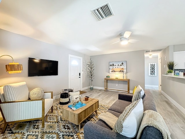 living room with ceiling fan and hardwood / wood-style floors