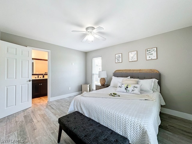 bedroom with ceiling fan, light hardwood / wood-style flooring, and ensuite bath