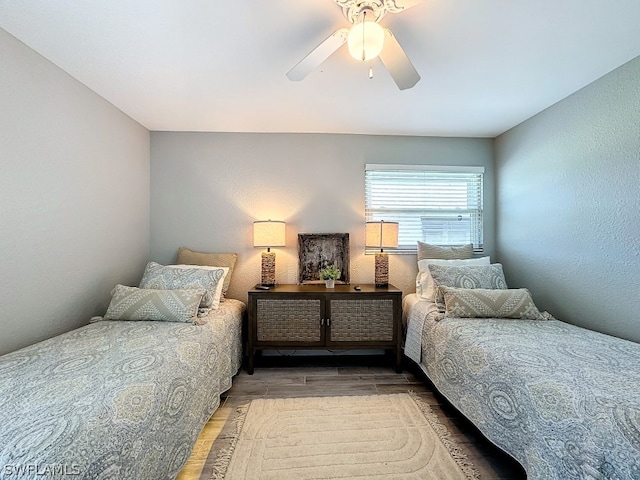 bedroom with ceiling fan and wood-type flooring