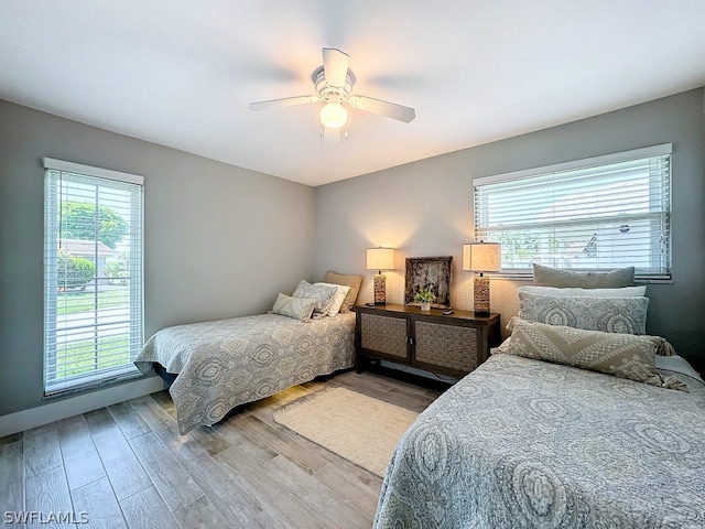 bedroom with hardwood / wood-style flooring and ceiling fan