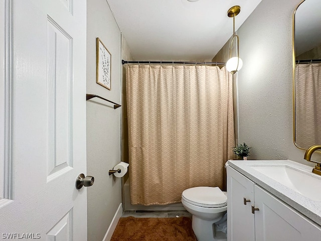 bathroom with tile floors, toilet, and large vanity