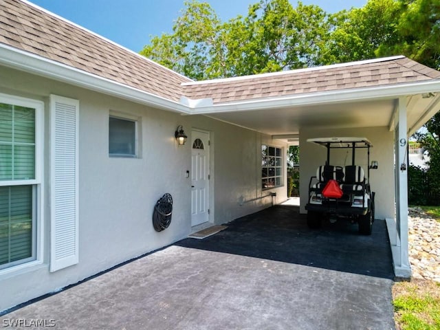 view of patio / terrace featuring an attached carport and asphalt driveway