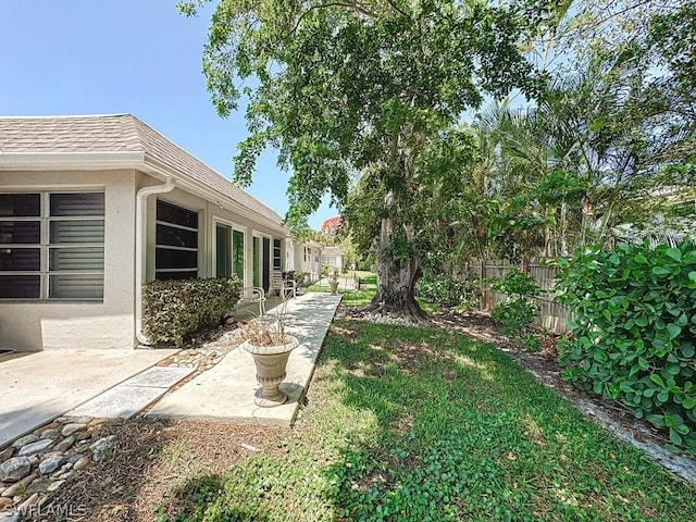view of yard featuring a patio area and fence