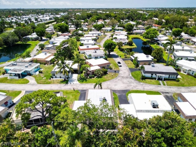 aerial perspective of suburban area with a nearby body of water
