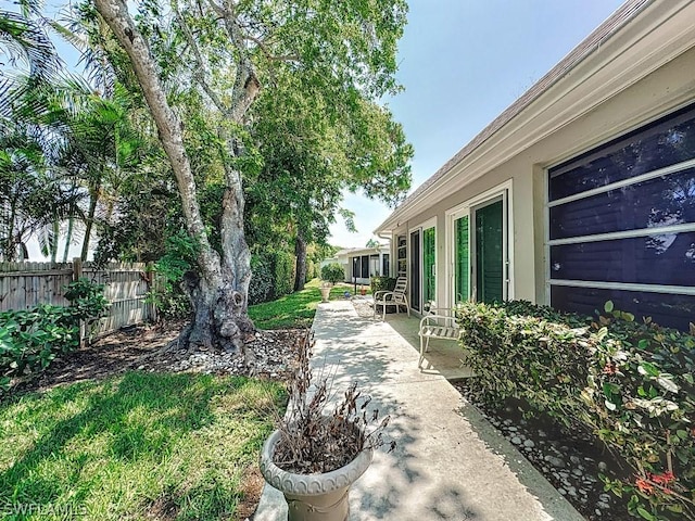 view of yard with fence and a patio