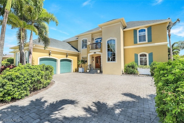 mediterranean / spanish-style house with a balcony and a garage