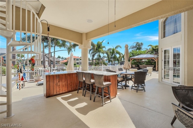 view of patio / terrace with a gazebo, an outdoor bar, and french doors