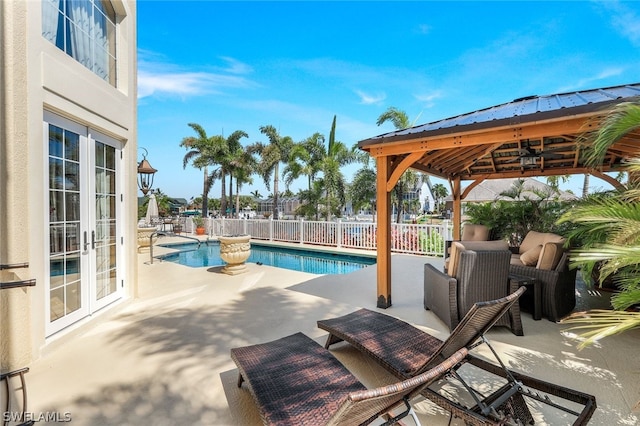 view of swimming pool featuring a gazebo, a patio, and french doors